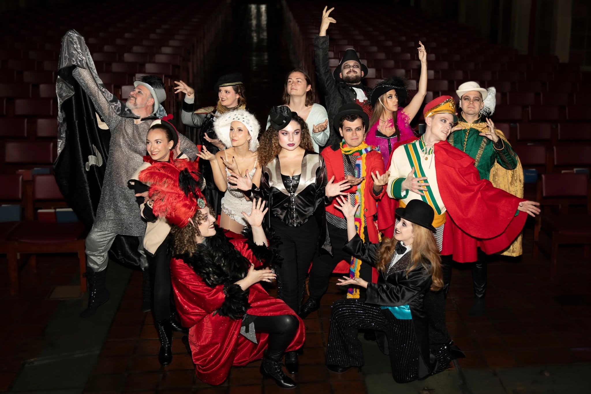 A theatrical ensemble posed together in costume
